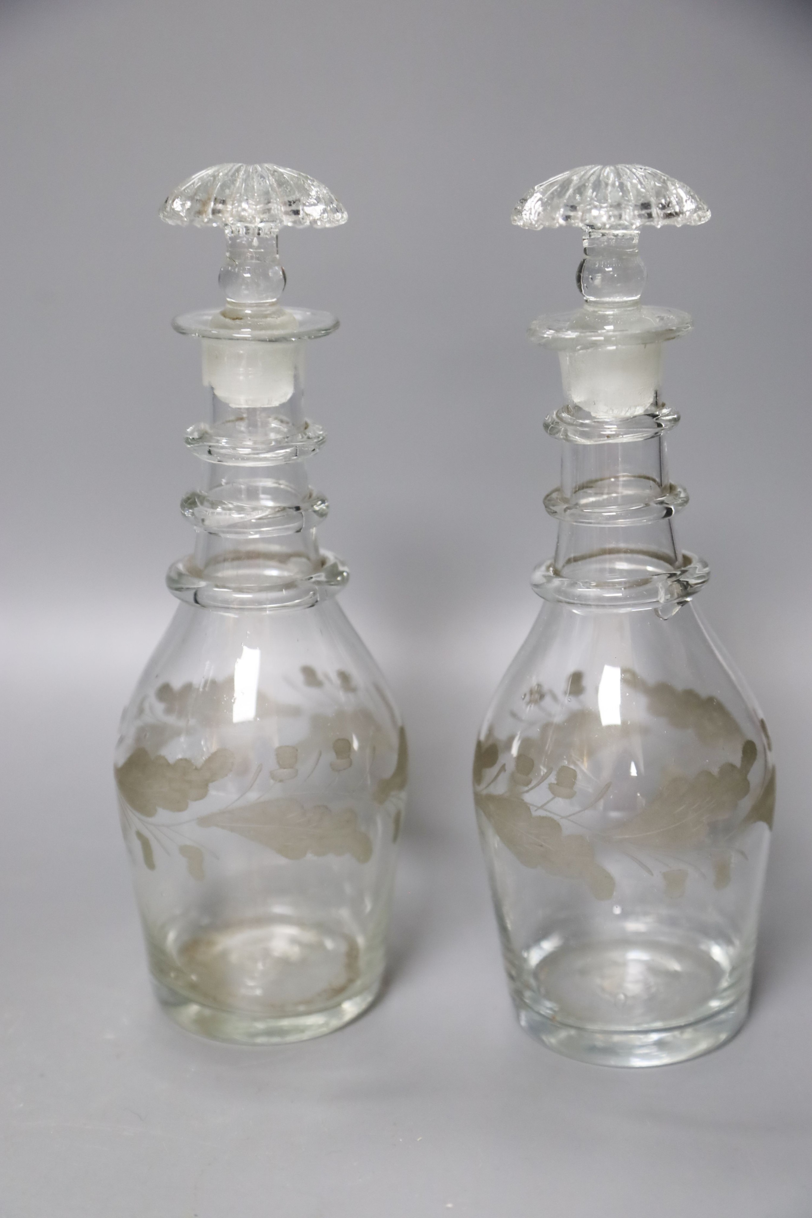 A pair of Regency small cut glass decanters, a pair of silver-mounted 'dimple' decanters, another pair of decanters and two other decanters.